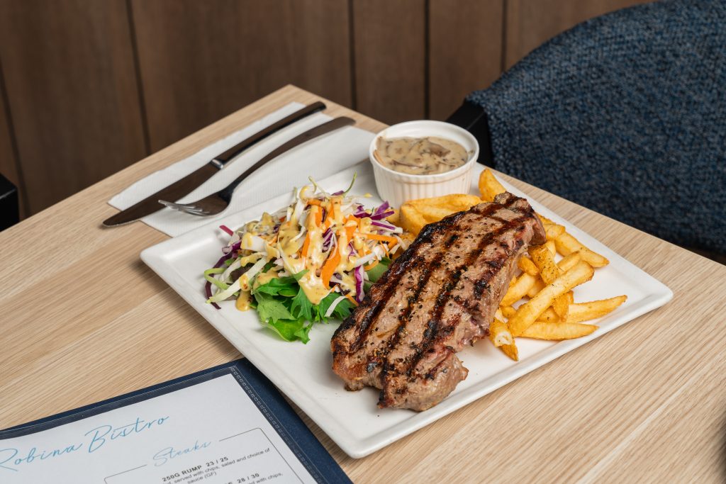 Steak with chips salad and mushroom gravy on a tabletop